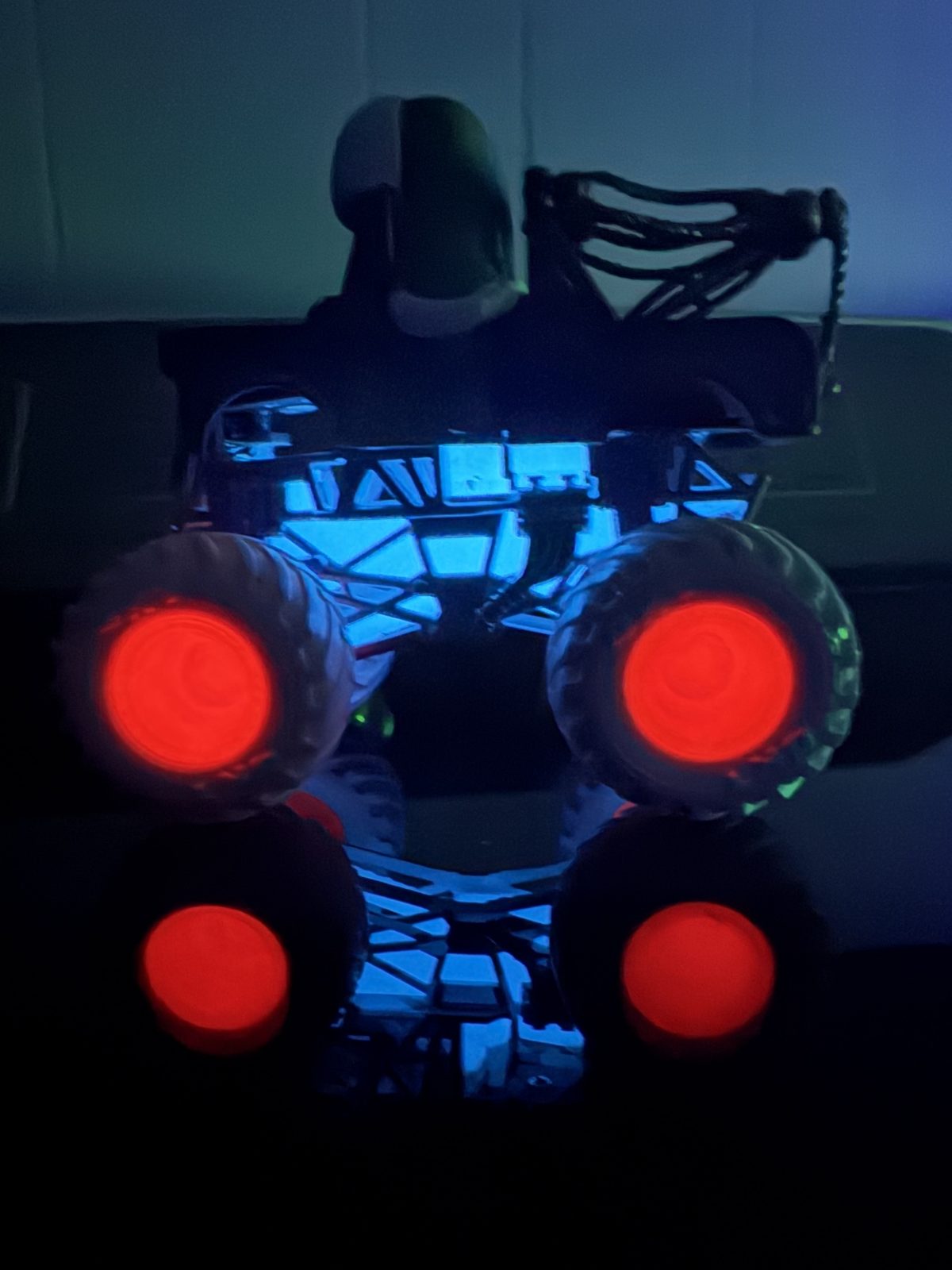 Custom monster truck build with red glowing wheels